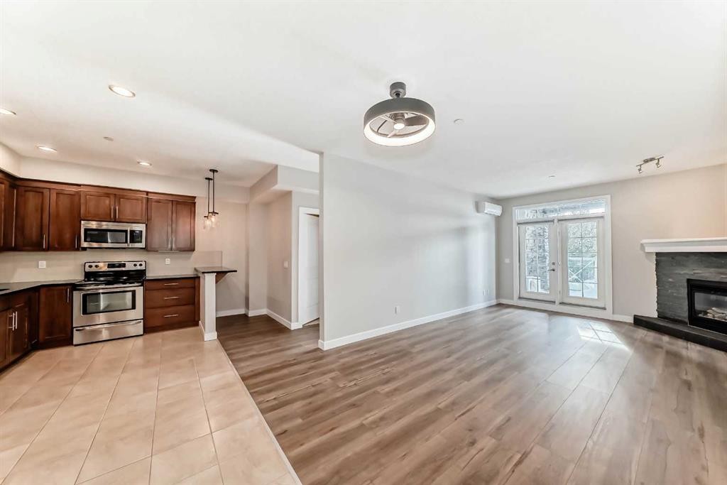 110-1005A Westmount Drive, Strathmore, AB - Indoor With Fireplace