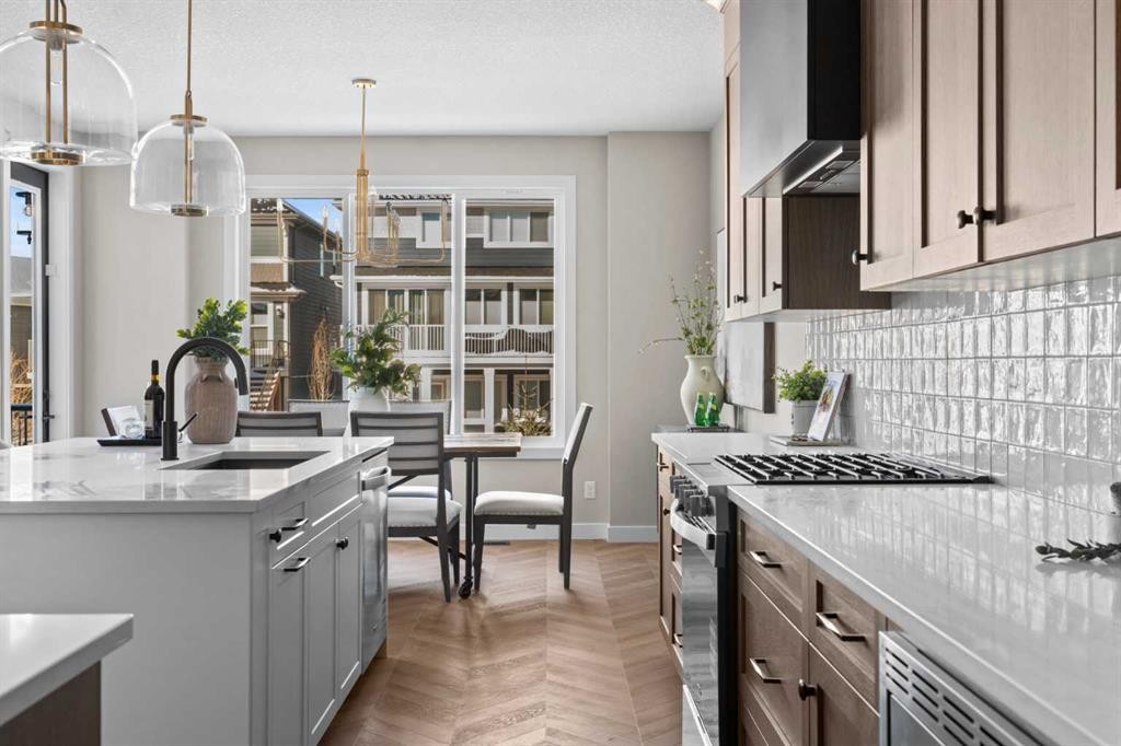 47 Sundown Crescent, Cochrane, AB - Indoor Photo Showing Kitchen With Upgraded Kitchen