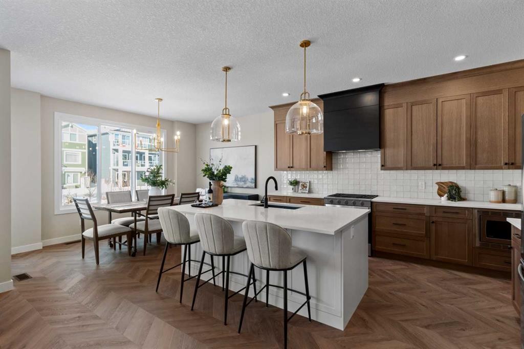 47 Sundown Crescent, Cochrane, AB - Indoor Photo Showing Kitchen With Upgraded Kitchen