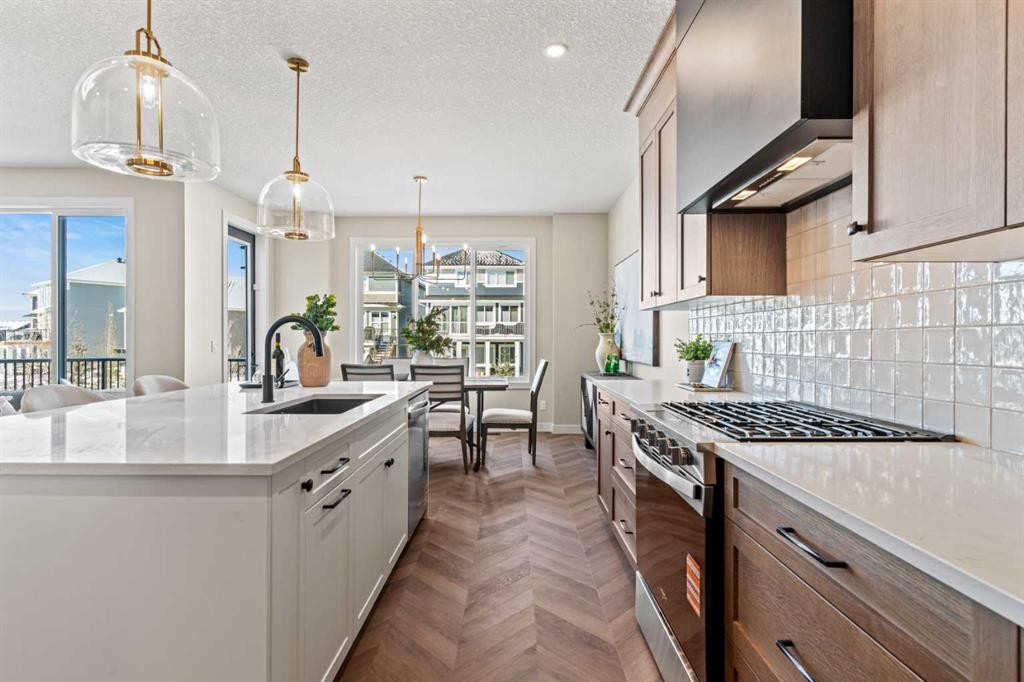 47 Sundown Crescent, Cochrane, AB - Indoor Photo Showing Kitchen With Upgraded Kitchen