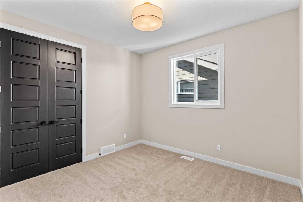 47 Sundown Crescent, Cochrane, AB - Indoor Photo Showing Other Room