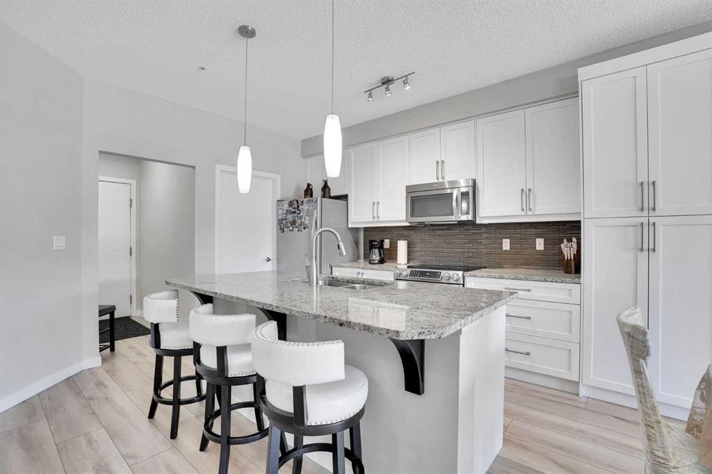 208-402 Marquis Lane Se, Calgary, AB - Indoor Photo Showing Kitchen With Upgraded Kitchen