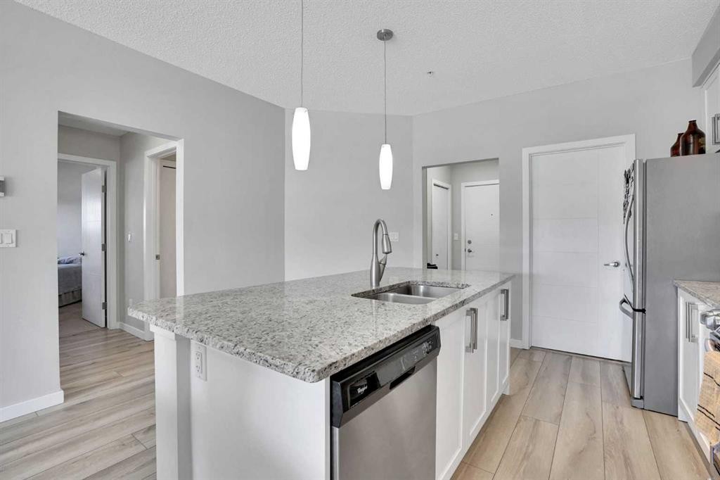 208-402 Marquis Lane Se, Calgary, AB - Indoor Photo Showing Kitchen With Double Sink With Upgraded Kitchen