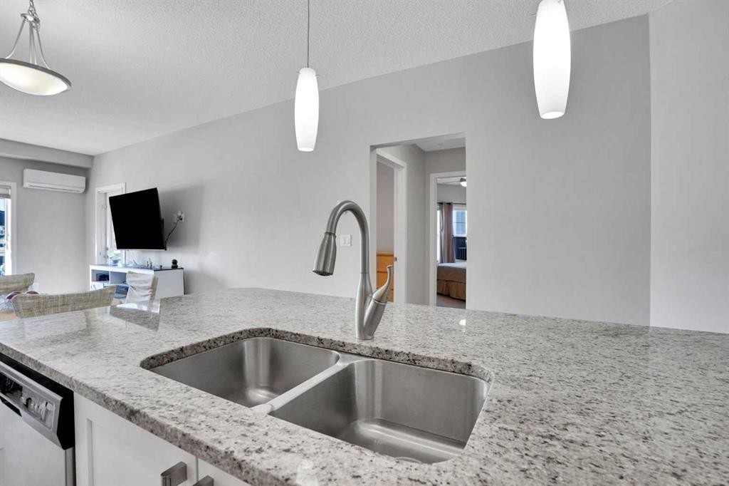 208-402 Marquis Lane Se, Calgary, AB - Indoor Photo Showing Kitchen With Double Sink