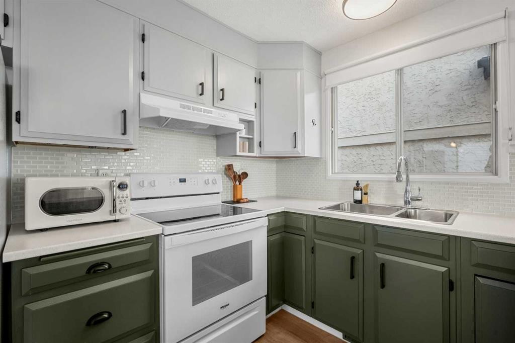 55 Coach Gate Way Sw, Calgary, AB - Indoor Photo Showing Kitchen With Double Sink