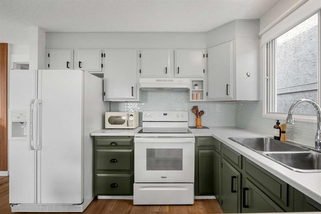 55 Coach Gate Way Sw, Calgary, AB - Indoor Photo Showing Kitchen With Double Sink