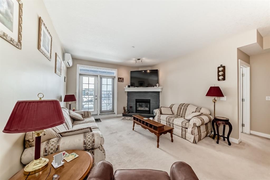 107-1005A Westmount Drive, Strathmore, AB - Indoor Photo Showing Living Room With Fireplace