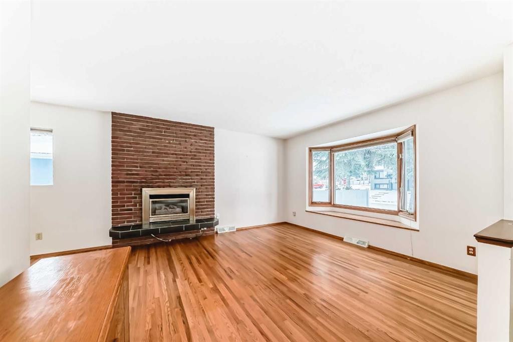 3408 Boulton Road Nw, Calgary, AB - Indoor Photo Showing Living Room With Fireplace