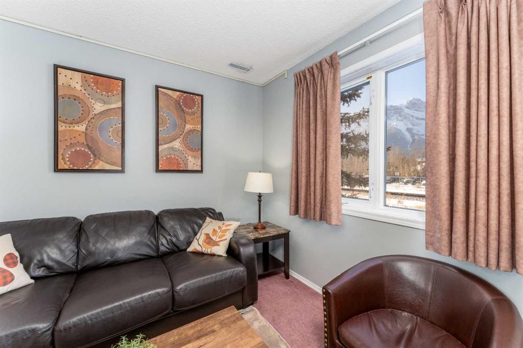 140-1202 Bow Valley Trail, Canmore, AB - Indoor Photo Showing Living Room