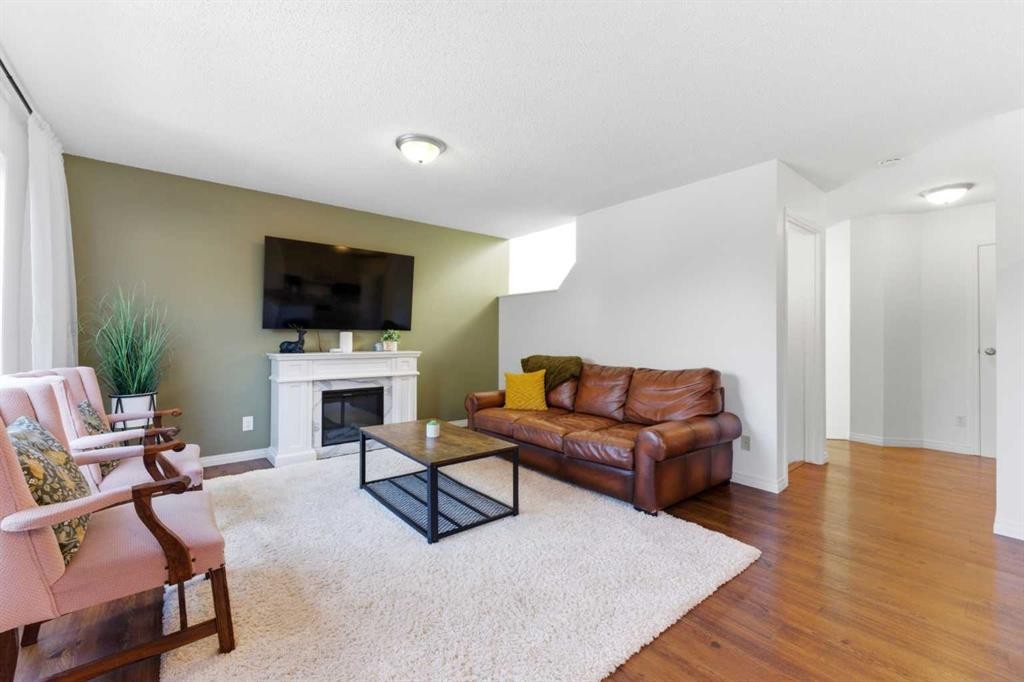 84 Mt Apex Green Se, Calgary, AB - Indoor Photo Showing Living Room With Fireplace
