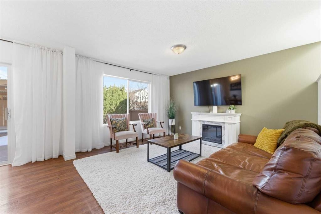 84 Mt Apex Green Se, Calgary, AB - Indoor Photo Showing Living Room With Fireplace