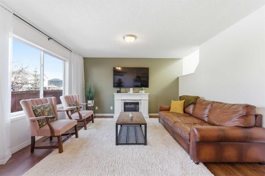 84 Mt Apex Green Se, Calgary, AB - Indoor Photo Showing Living Room With Fireplace