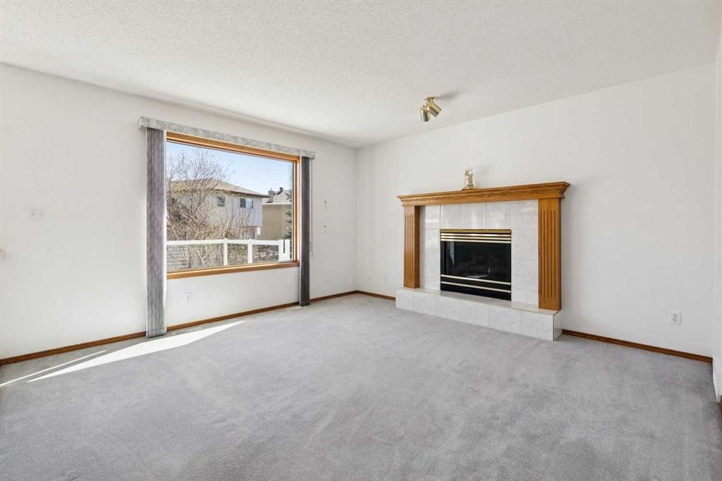 135 Sceptre Close Nw, Calgary, AB - Indoor Photo Showing Living Room With Fireplace