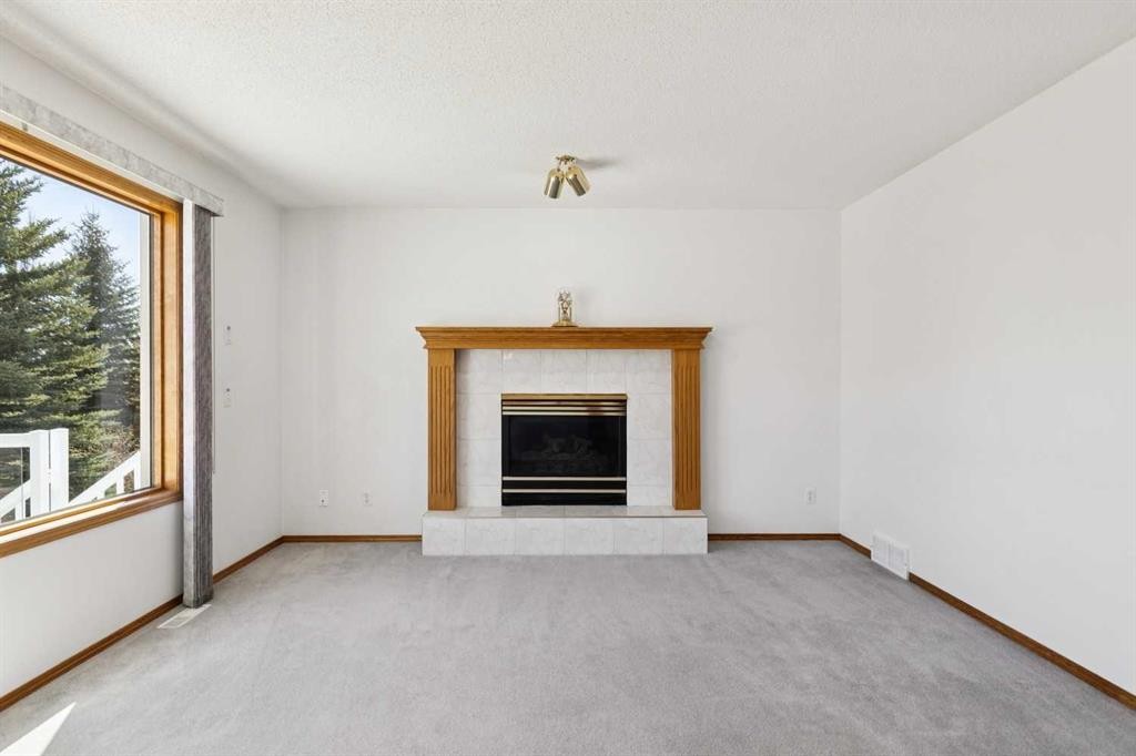 135 Sceptre Close Nw, Calgary, AB - Indoor Photo Showing Living Room With Fireplace