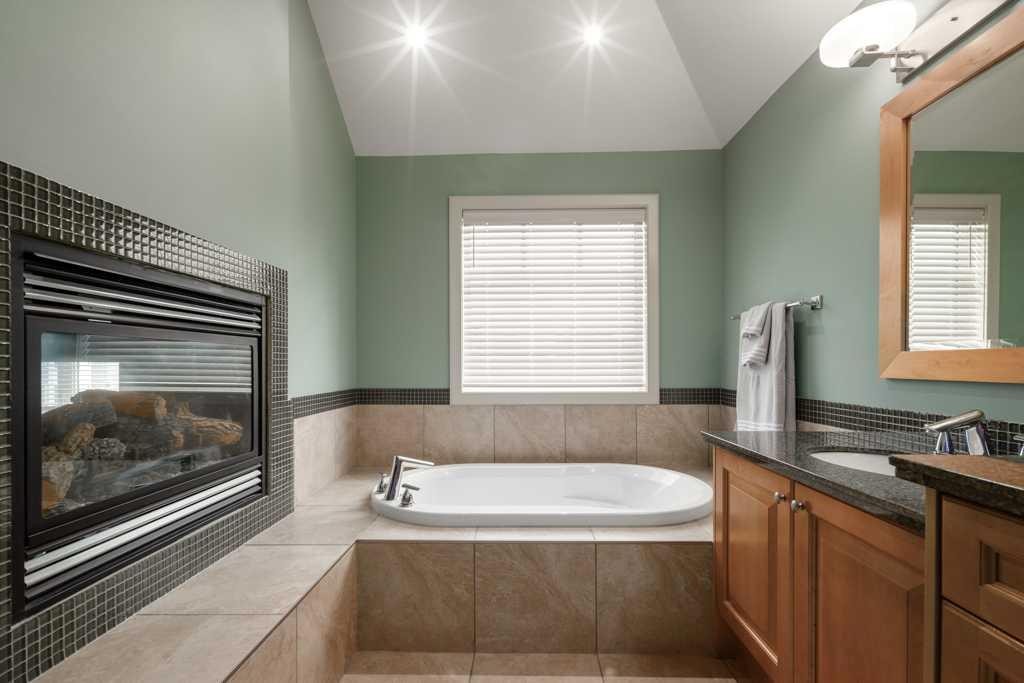 24 Aspen Meadows Green Sw, Calgary, AB - Indoor Photo Showing Bathroom With Fireplace