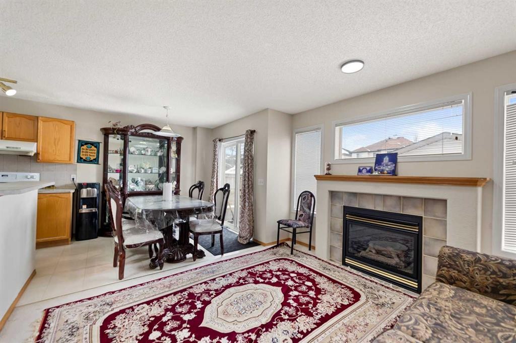 101 Taravista Crescent, Calgary, AB - Indoor Photo Showing Living Room With Fireplace