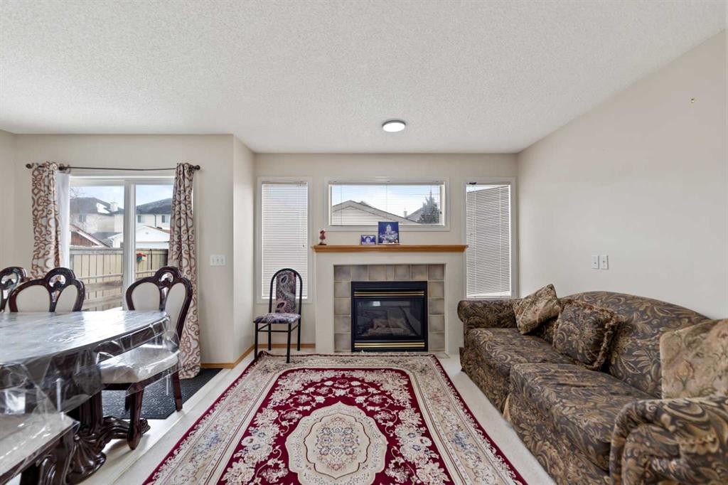 101 Taravista Crescent, Calgary, AB - Indoor Photo Showing Living Room With Fireplace