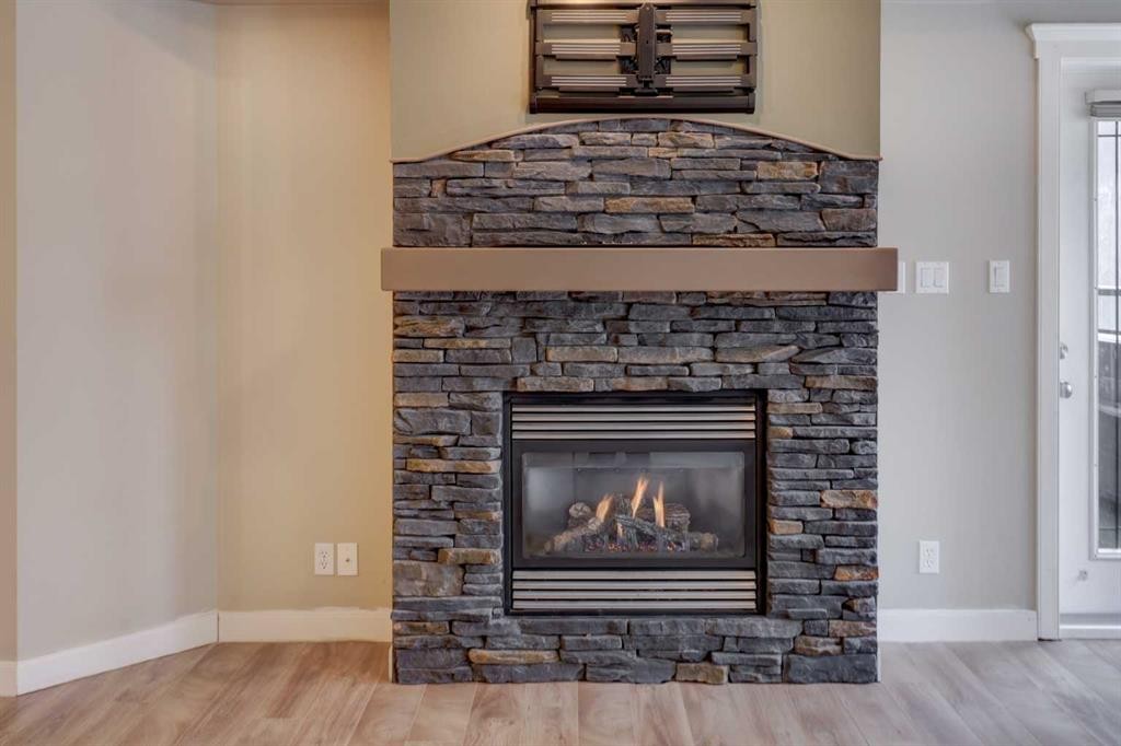 209-10 Discovery Ridge Close Sw, Calgary, AB - Indoor Photo Showing Living Room With Fireplace
