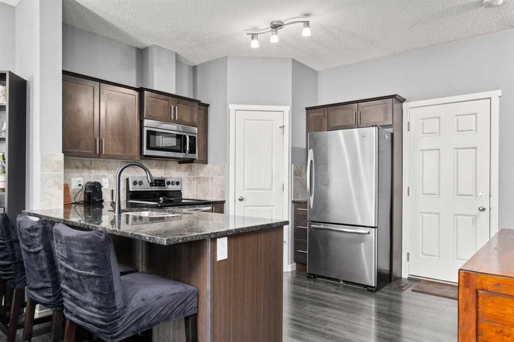 15 Copperpond Landing Se, Calgary, AB - Indoor Photo Showing Kitchen With Double Sink