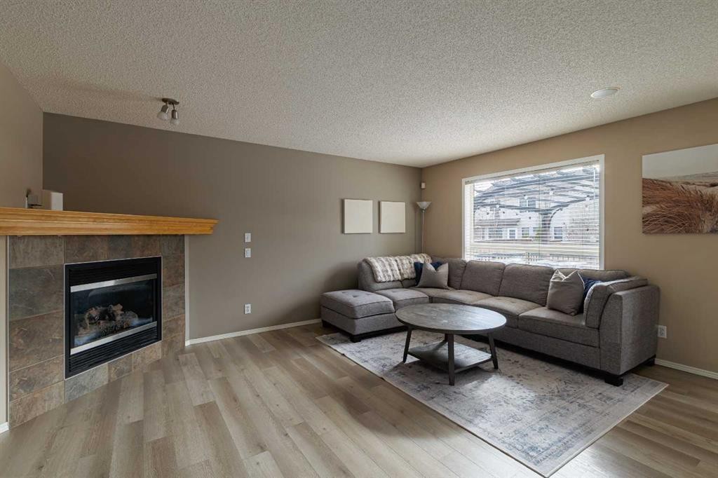 51 Brightondale Crescent Se, Calgary, AB - Indoor Photo Showing Living Room With Fireplace