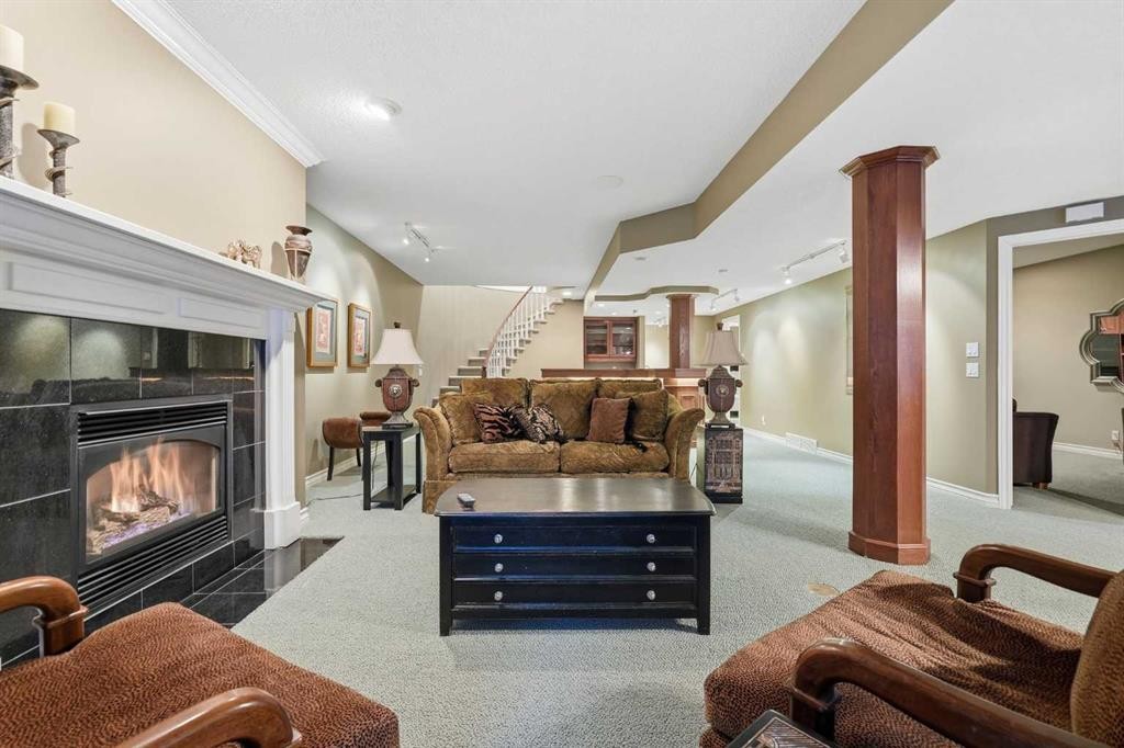 23 Prominence Point Sw, Calgary, AB - Indoor Photo Showing Living Room With Fireplace