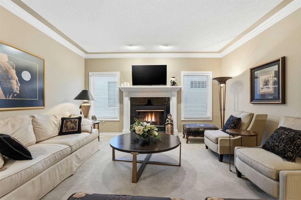 23 Prominence Point Sw, Calgary, AB - Indoor Photo Showing Living Room With Fireplace