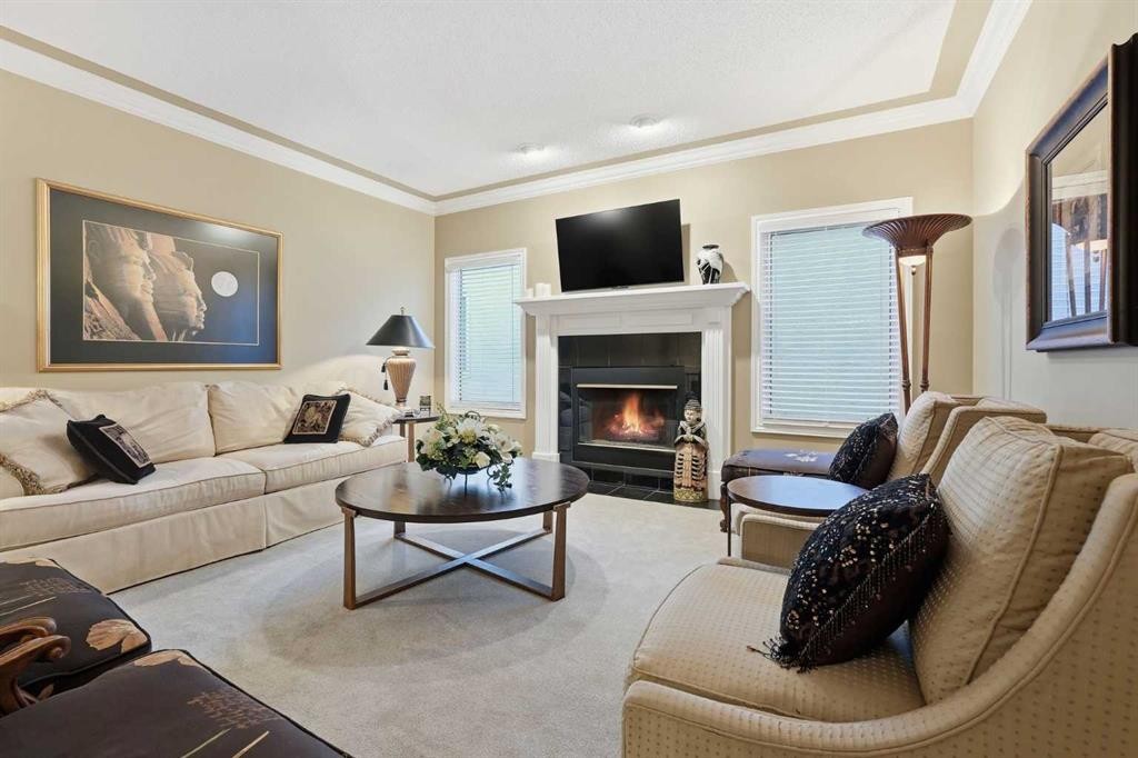 23 Prominence Point Sw, Calgary, AB - Indoor Photo Showing Living Room With Fireplace