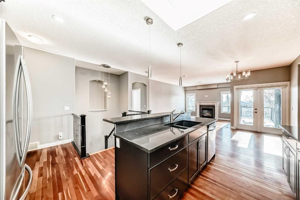 88 Sunset Circle, Cochrane, AB - Indoor Photo Showing Kitchen With Double Sink With Upgraded Kitchen