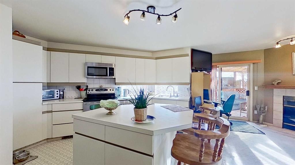 2219 Westmount Road Nw, Calgary, AB - Indoor Photo Showing Kitchen With Fireplace