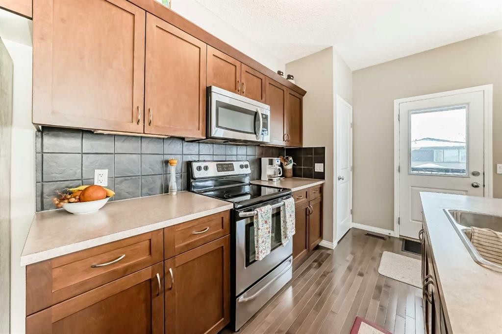 266 Fireside Place, Cochrane, AB - Indoor Photo Showing Kitchen With Double Sink