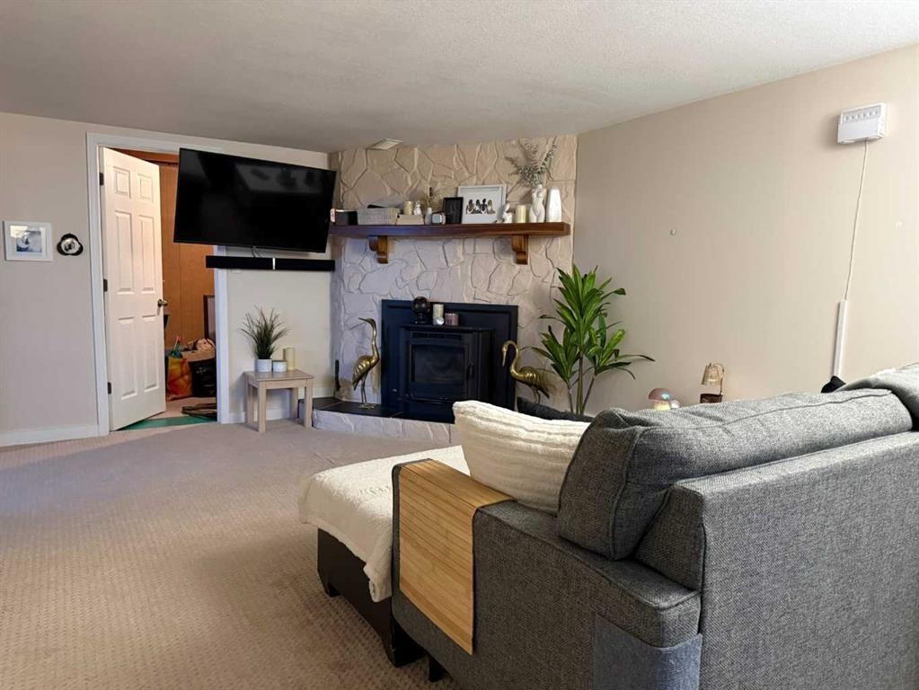 37 Arbour Crescent Se, Calgary, AB - Indoor Photo Showing Living Room With Fireplace
