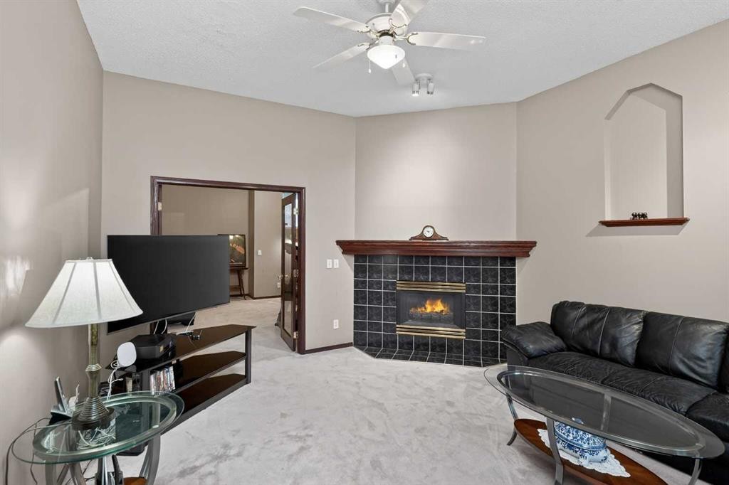 150 Somerset Close Sw, Calgary, AB - Indoor Photo Showing Living Room With Fireplace