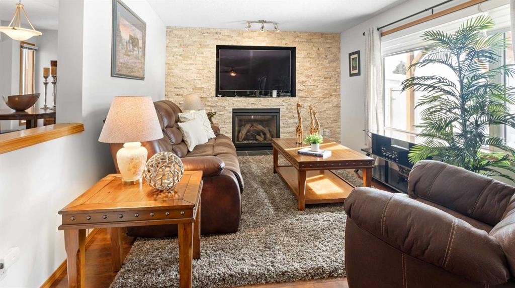 323 Mt Cornwall Circle Se, Calgary, AB - Indoor Photo Showing Living Room With Fireplace