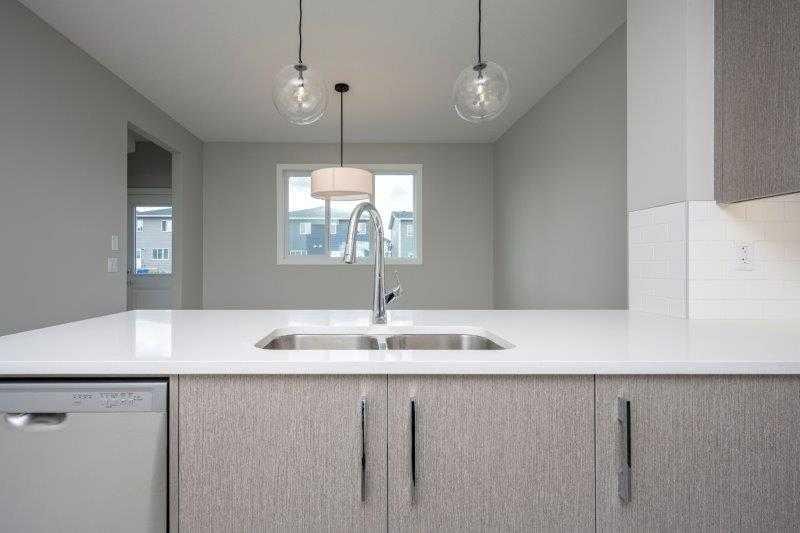 141 Dawson Wharf View, Chestermere, AB - Indoor Photo Showing Kitchen With Double Sink