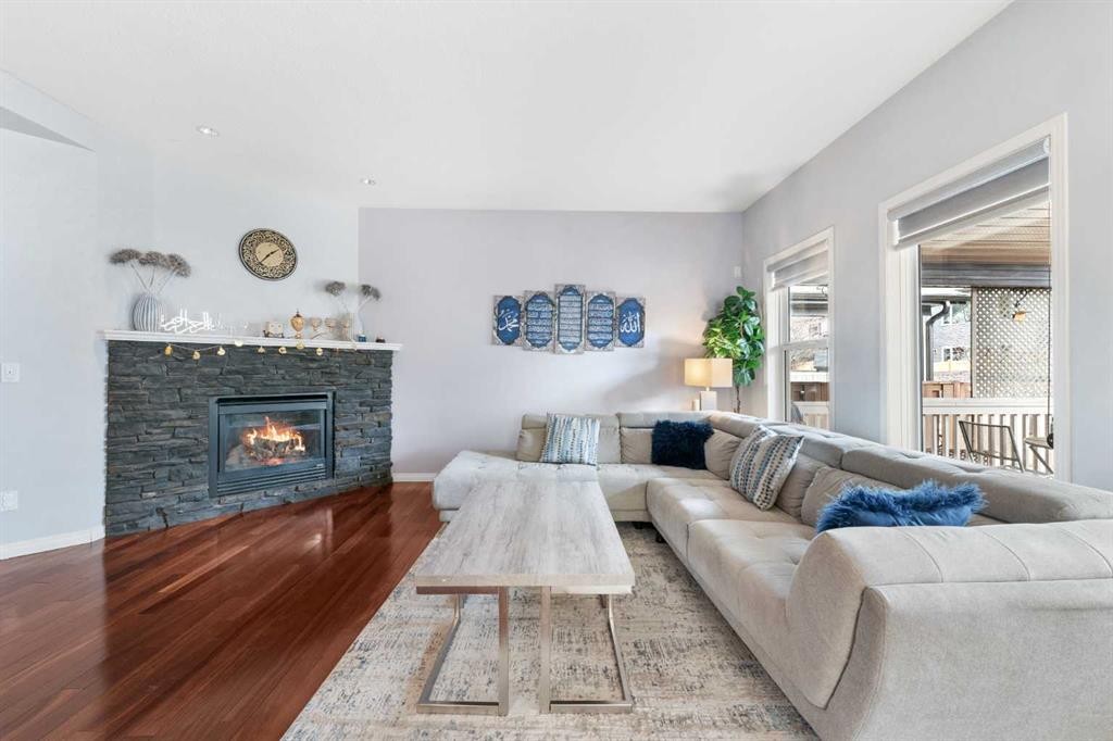 72 Panamount Heights Nw, Calgary, AB - Indoor Photo Showing Living Room With Fireplace
