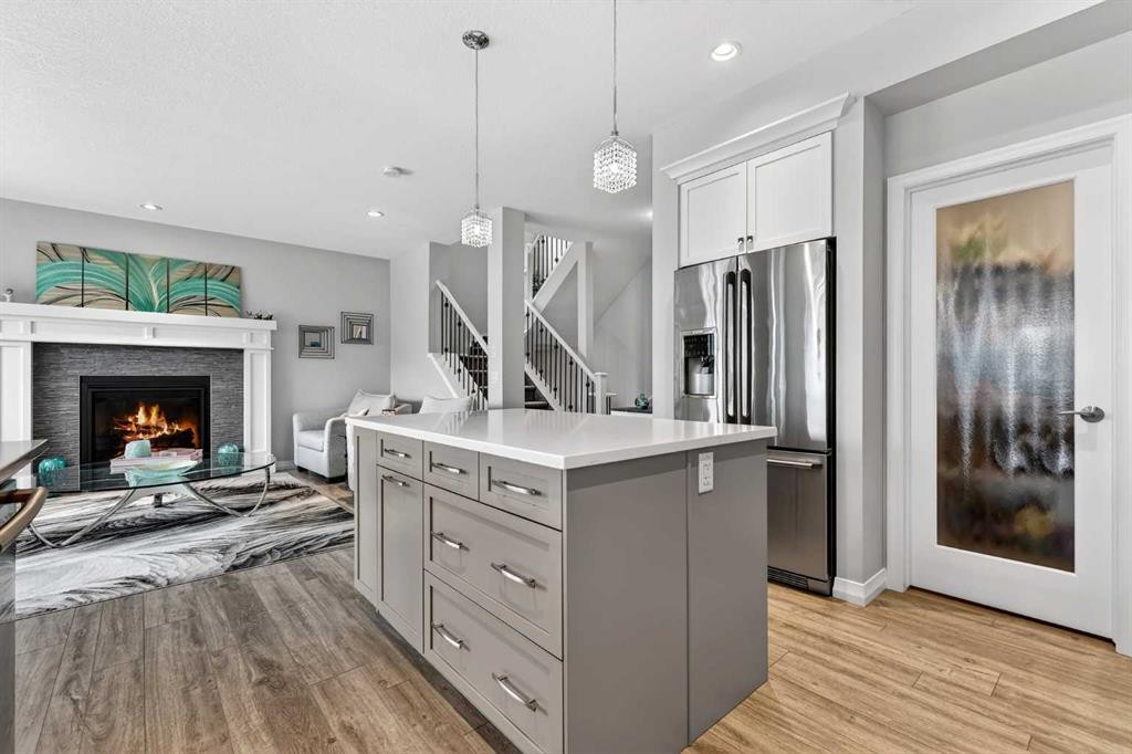 142 Masters Common Se, Calgary, AB - Indoor Photo Showing Kitchen With Fireplace With Stainless Steel Kitchen With Upgraded Kitchen