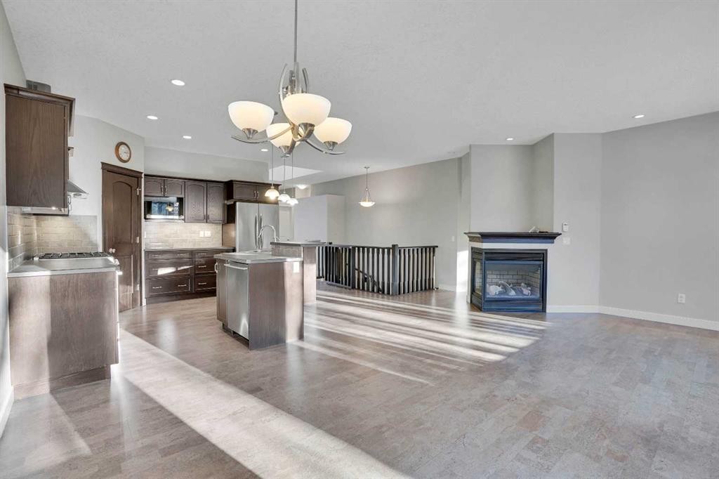 27-925 Imperial Drive, Diamond Valley, AB - Indoor Photo Showing Kitchen With Fireplace