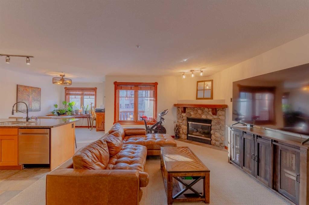313-170 Crossbow Place, Canmore, AB - Indoor Photo Showing Living Room With Fireplace