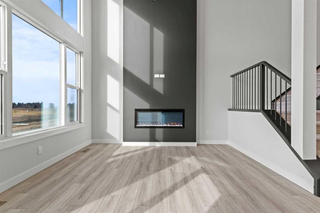 302 Kinniburgh Loop, Chestermere, AB - Indoor Photo Showing Living Room With Fireplace
