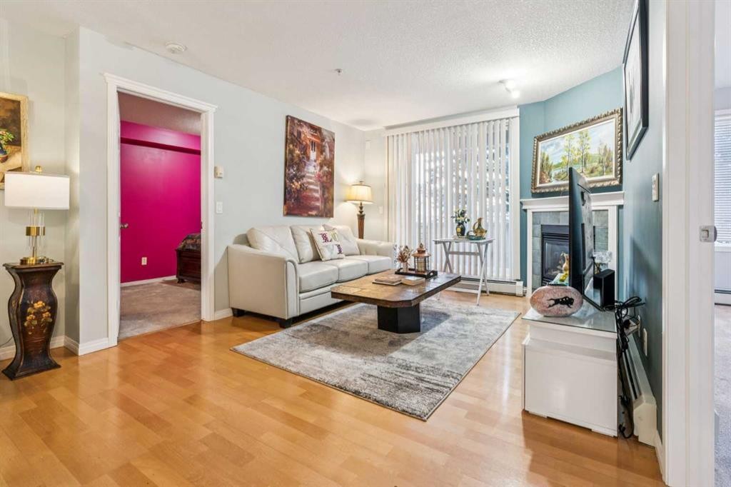 105-15320 Bannister Road Se, Calgary, AB - Indoor Photo Showing Living Room With Fireplace
