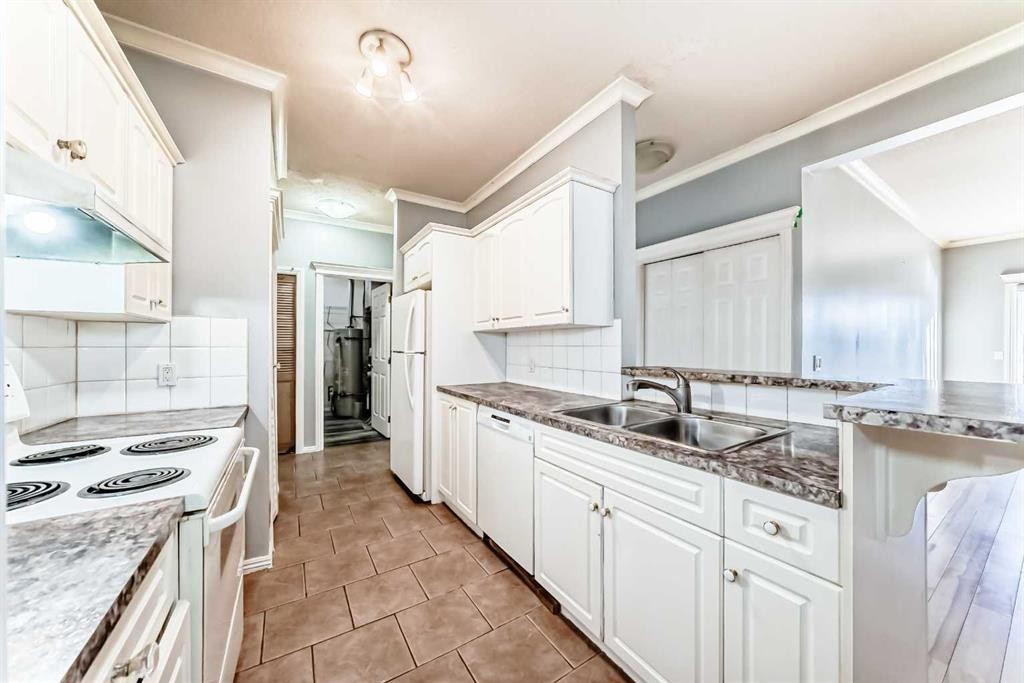 205-7 Lineham Avenue, Okotoks, AB - Indoor Photo Showing Kitchen With Double Sink