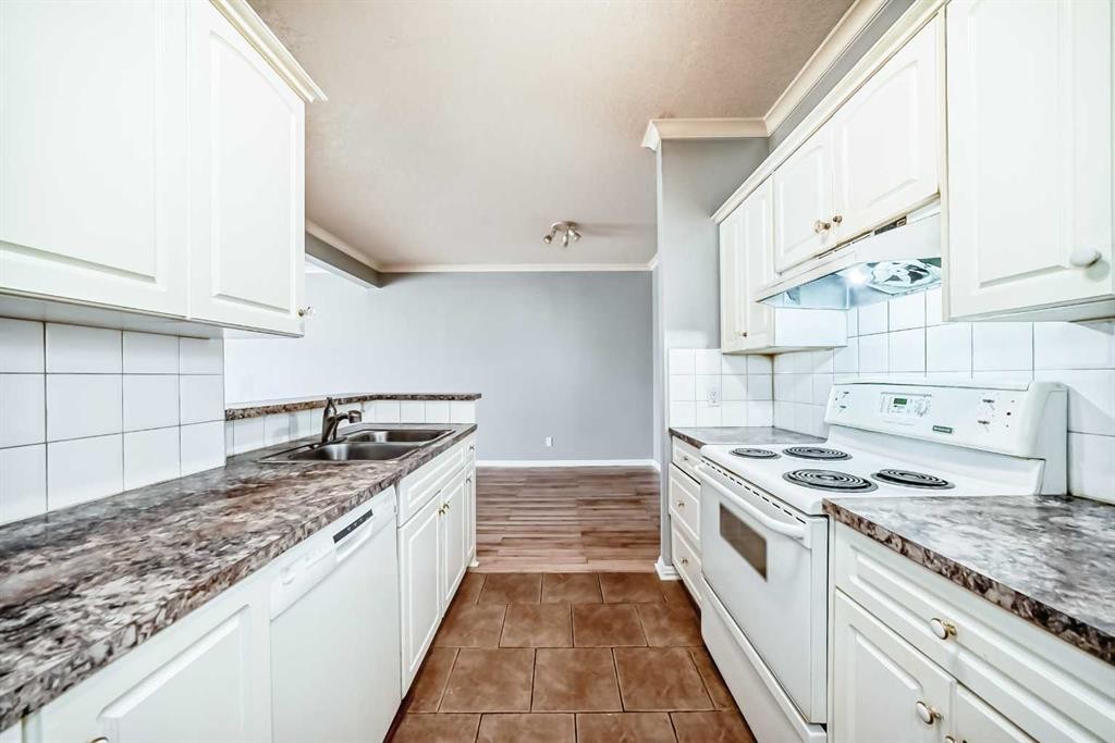 205-7 Lineham Avenue, Okotoks, AB - Indoor Photo Showing Kitchen With Double Sink