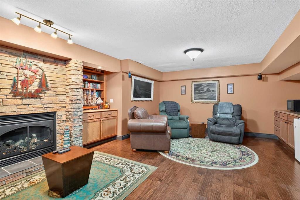 125 Copeland Close, Langdon, AB - Indoor Photo Showing Living Room With Fireplace