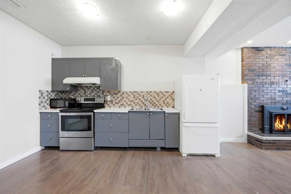 6011 Temple Drive Ne, Calgary, AB - Indoor Photo Showing Kitchen With Fireplace