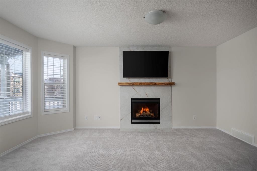641 Evermeadow Road Sw, Calgary, AB - Indoor Photo Showing Living Room With Fireplace