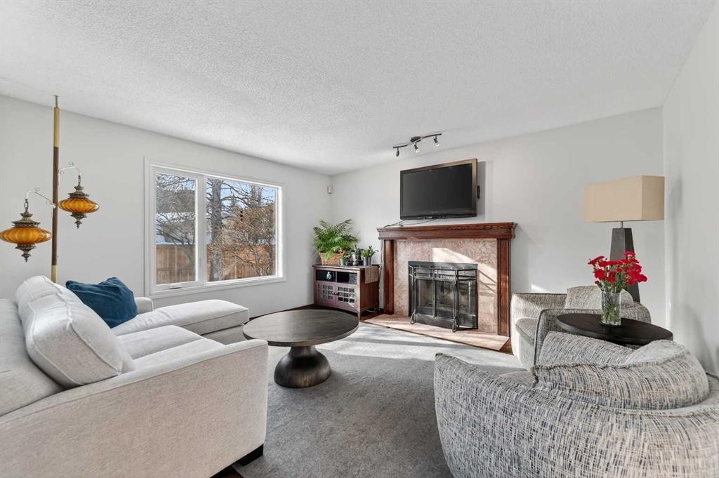 52 Riverwood Circle Se, Calgary, AB - Indoor Photo Showing Living Room With Fireplace