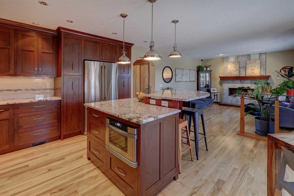 66 Scimitar Point Nw, Calgary, AB - Indoor Photo Showing Kitchen With Fireplace