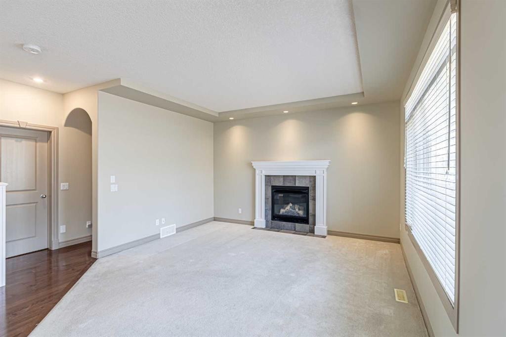 67 Evergreen Row Sw, Calgary, AB - Indoor Photo Showing Living Room With Fireplace