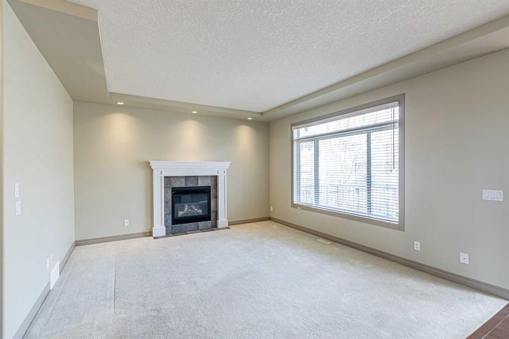 67 Evergreen Row Sw, Calgary, AB - Indoor Photo Showing Living Room With Fireplace