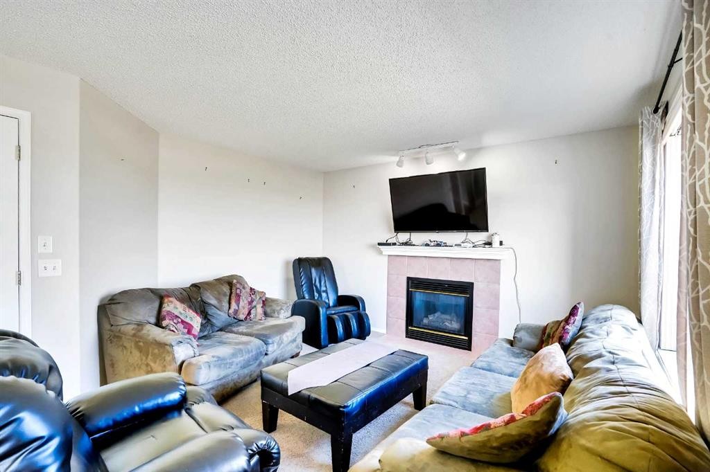 69 Coral Springs Park Ne, Calgary, AB - Indoor Photo Showing Living Room With Fireplace